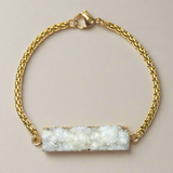 Warm Aurelia bracelet with ivory druzy agate and 18K gold steel chain, softly shimmering with refined texture
