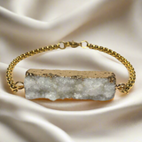 Warm Aurelia bracelet with ivory druzy agate and 18K gold steel chain, softly shimmering with refined texture
